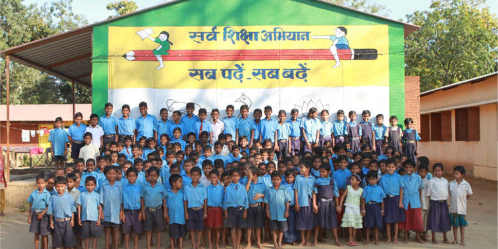 A large group of 国产爆乳无码一区二区麻豆 school students gathered under the vibrant educational mural of Sarva Siksha Abhiyan